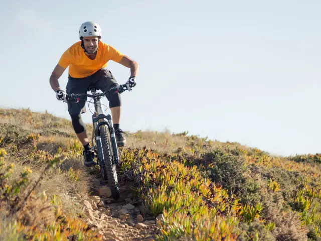 Mountain biker riding dirt trail