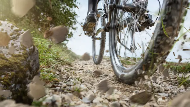 Mountain bike wheel on a gravel track